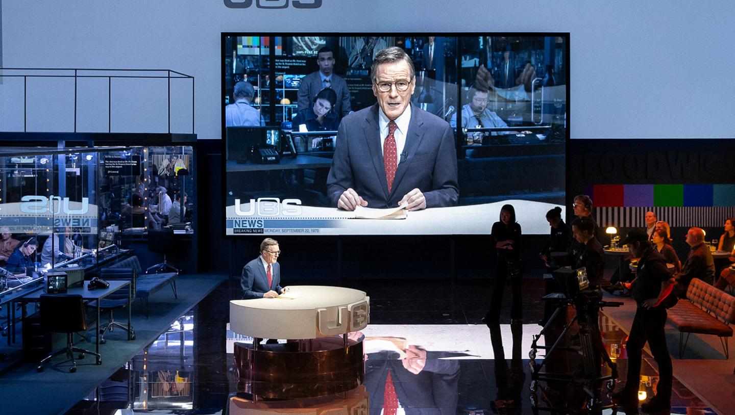 Bryan Cranston performing as news anchor on broadway theatre production