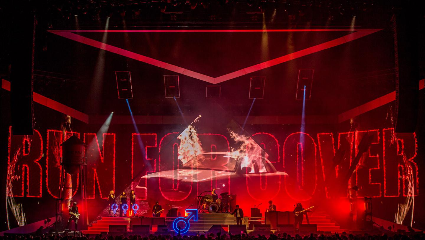 The killers playing live on stage with a various visual designs